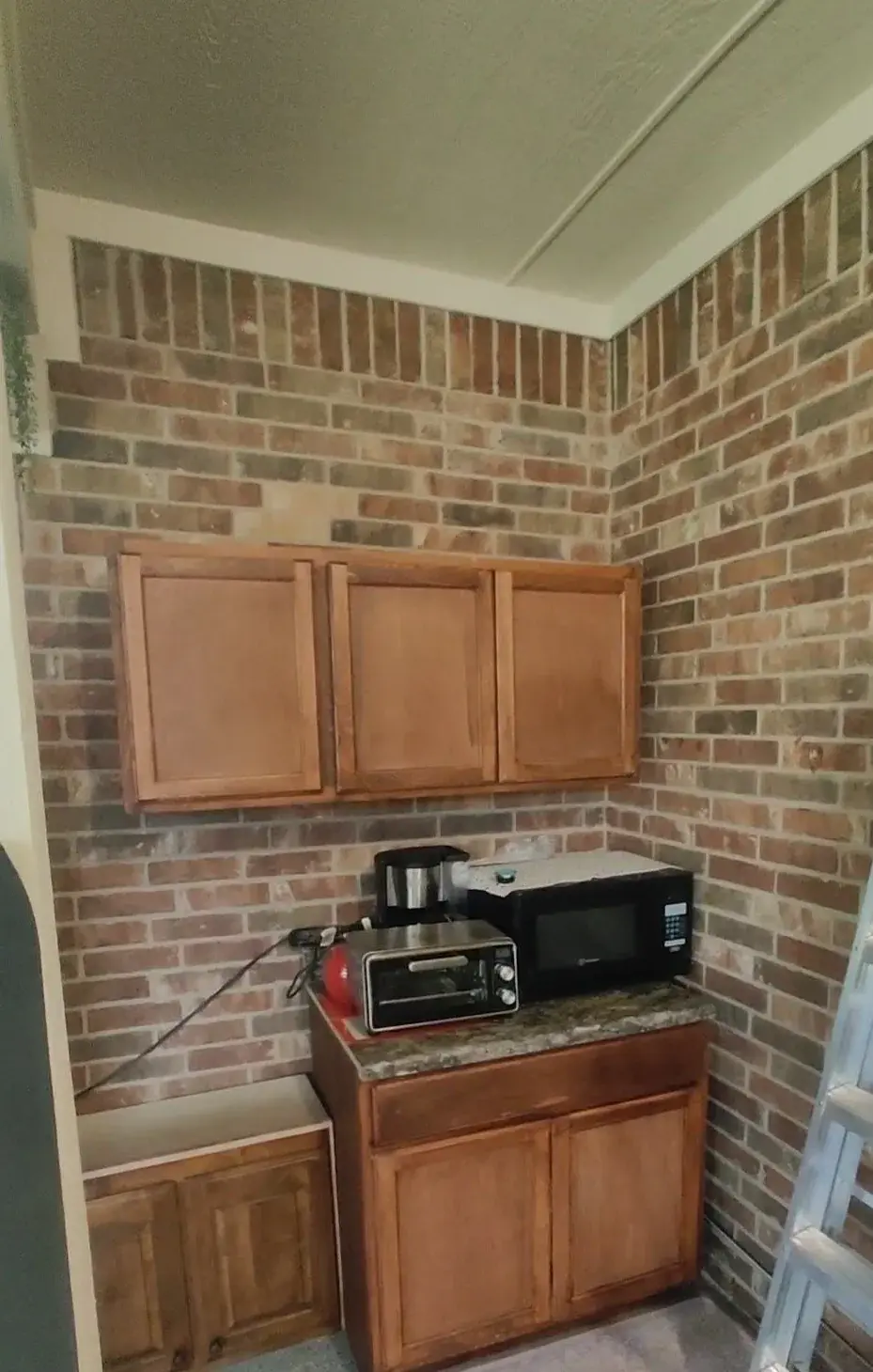Brick patio wall cabinet installation