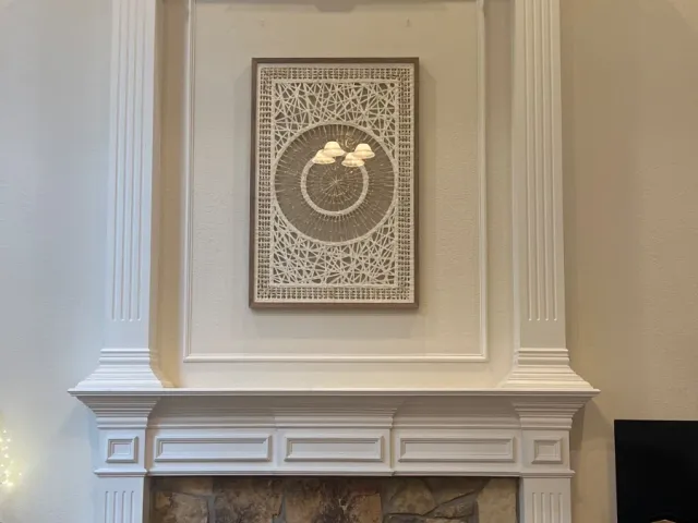 Large Artwork Installation Above Fireplace