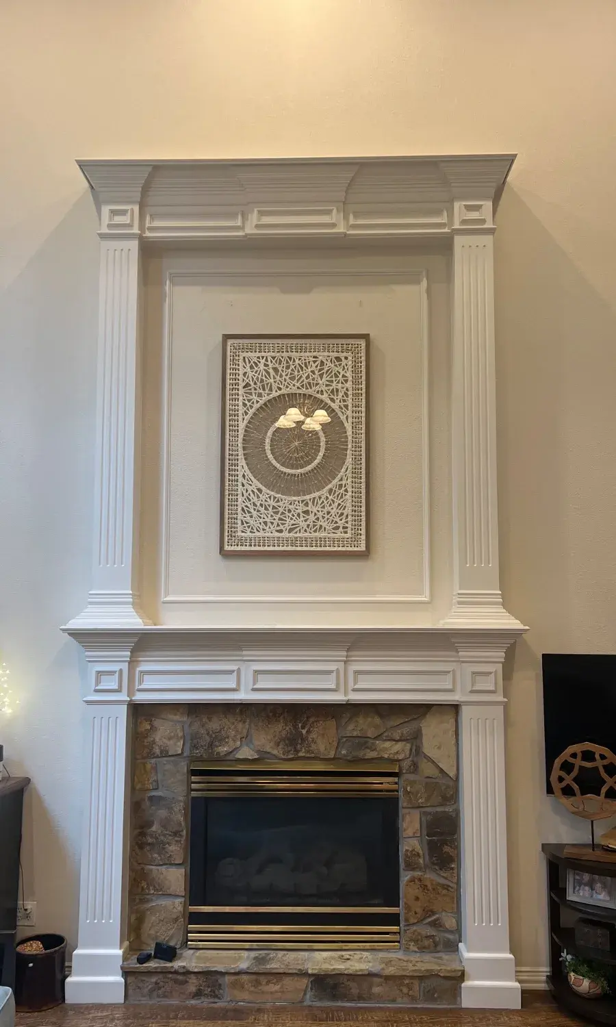 Large Artwork Installation Above Fireplace
