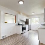Modern Dallas kitchen remodel with white cabinets and hardwood floors