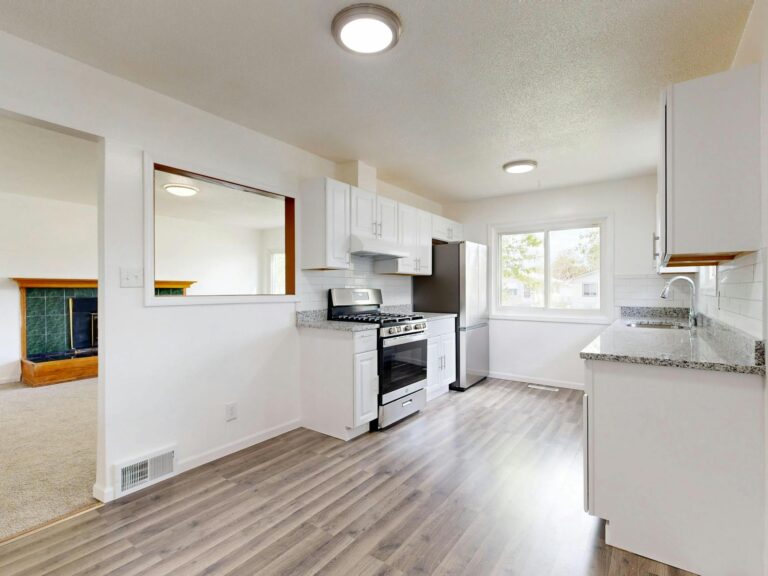 Modern Dallas kitchen remodel with white cabinets and hardwood floors