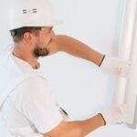 Professional handyman installing drywall in a Houston home