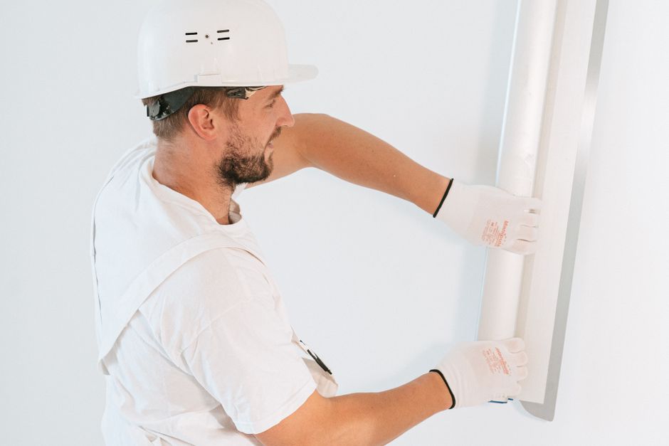 Professional handyman installing drywall in a Houston home